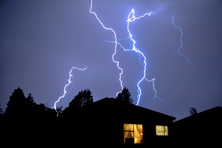 Home with lightning in the sky at night